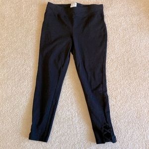 Women’s black small crop legging with criss cross cut out at ankles. Size S